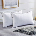 Set of two white pillows with dark piping